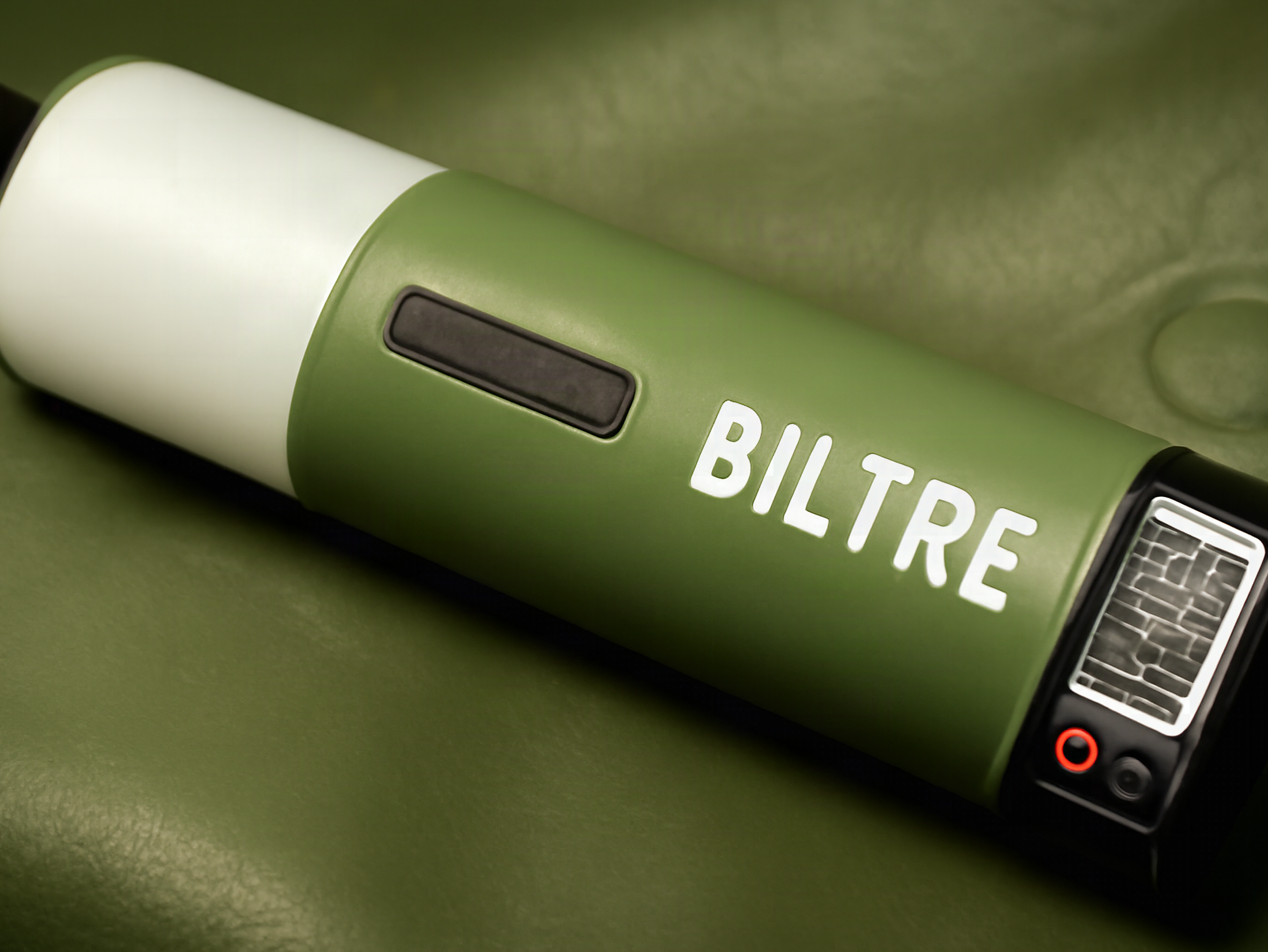 Macro close-up of the green inflatable solar lantern showing magnetic hanging strip and USB-C charging port
