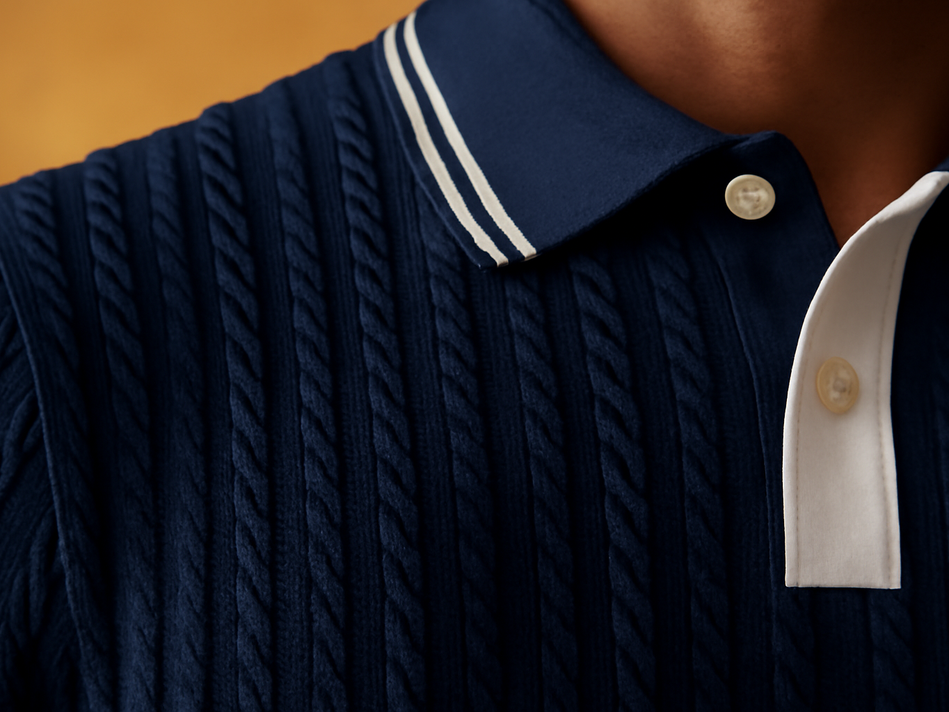 Macro close-up of navy textured knit polo shirt collar and weave detail